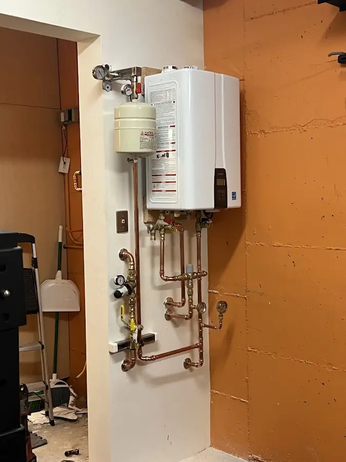 Plumbing technician inspecting water heater connections in Sweden